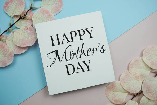 istock Happy Mother's Day text message with artificial leave on blue and pink background 2158765261