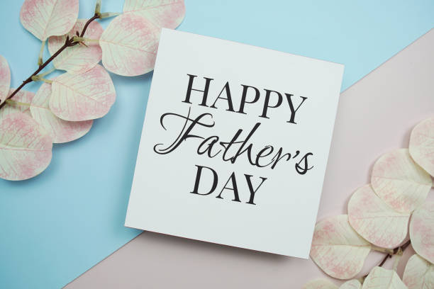 istock Happy Father's Day text message with artificial leave on blue and pink background 2158765321