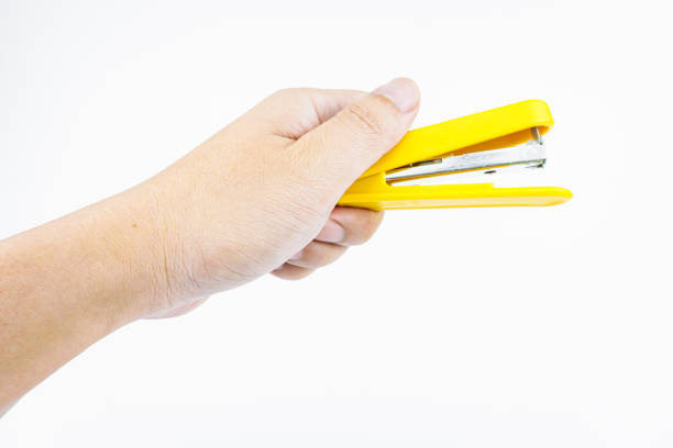 istock Woman holding yellow stapler on white background, closeup 2158768941