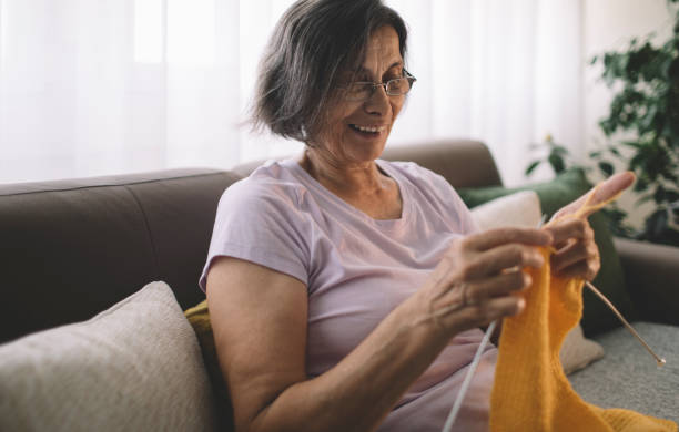 istock Smiling senior woman knitting 2158770591