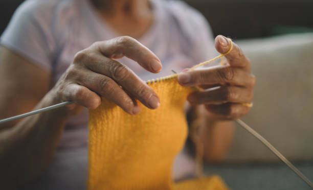 istock Close-up of woman's hands knitting 2158770601