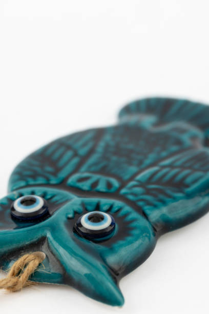 Decorative blue ceramic owl figurine isolated on white background.
