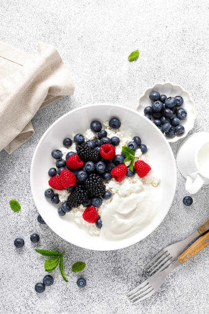 istock Cheese cottage with yogurt and fresh berries. Curd with blueberry, raspberry and blackberry, top view 2158772726