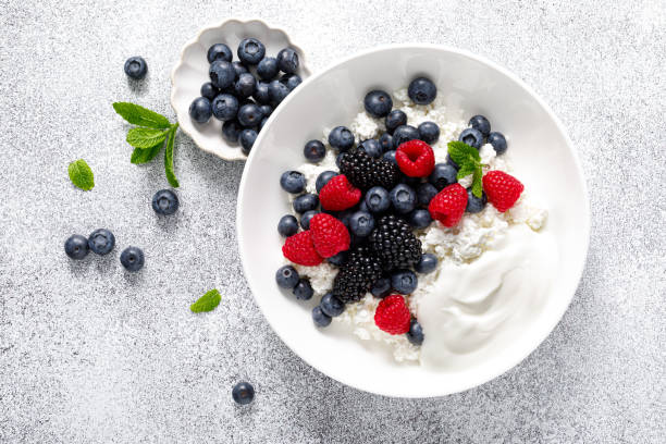 istock Cheese cottage with yogurt and fresh berries. Curd with blueberry, raspberry and blackberry, top view 2158772727