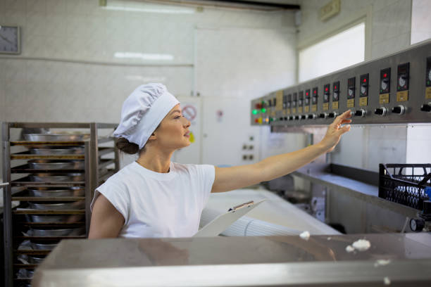 Lady dipping her chocolate bar into walnuts