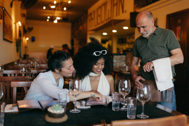 istock Two Young Women Ordering Food in a Restaurant 2158774284