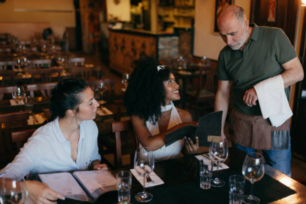 istock Two Young Women Ordering Food in a Restaurant 2158774286