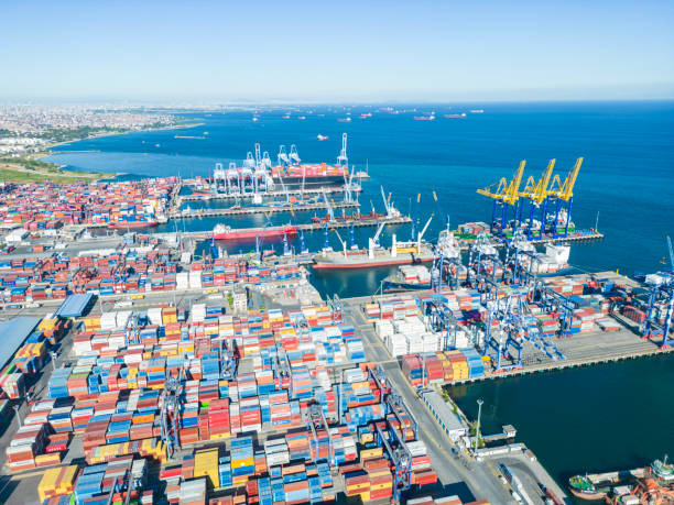 istock High angle view of  container cargo freight ship with working crane bridge  at import harbor, Istanbul, Turkey 2158776940