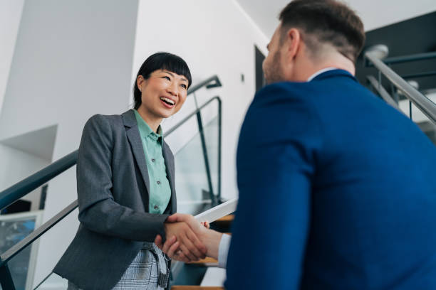 istock Professionals meeting and shaking hands on stairs. 2158777016