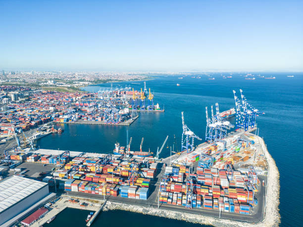 istock High angle view of  container cargo freight ship with working crane bridge  at import harbor, Istanbul, Turkey 2158777329
