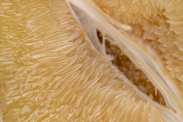 peeled pomelo slices in close-up, ripe and juicy pomelo without peel