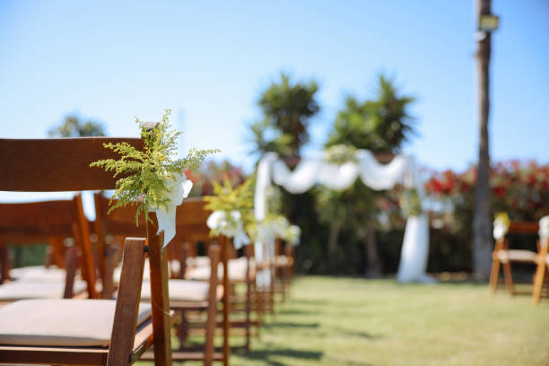 Romantic wedding ceremony. Beautiful setting for outdoors wedding ceremony waiting for bride and groom and guests. Decoration