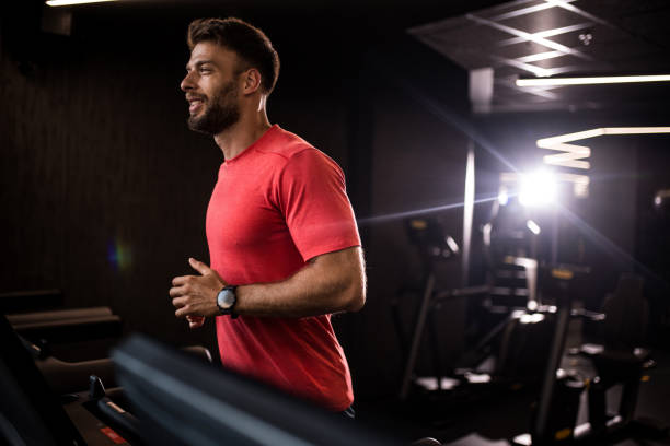 istock Athletic man running on treadmill in a gym. 2158784405