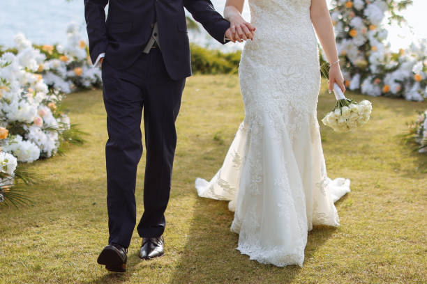 Happy bride and groom on their wedding hugging. Closeup Bride holding a bouquet
