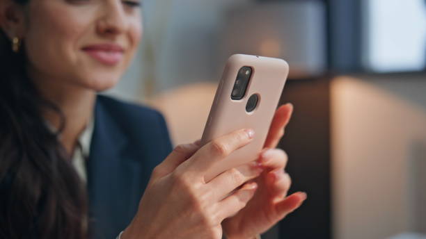 istock Smiling manager looking smartphone screen at modern office workplace closeup 2158784559