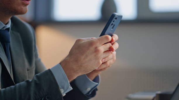 istock Man hands messaging smartphone sitting office closeup. Boss holding telephone 2158785871