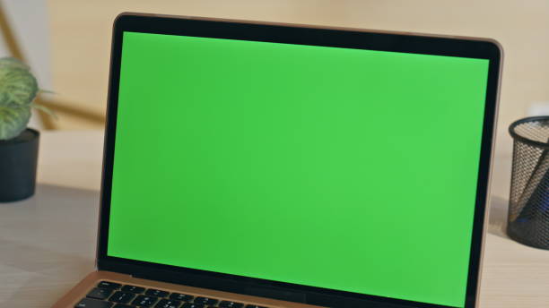 istock Modern green screen laptop placed on desk closeup. Empty chroma key computer 2158785918
