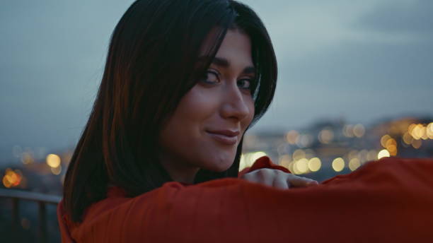 istock Closeup smiling brunette posing twilight cityscape. Romantic lady looking camera 2158786473