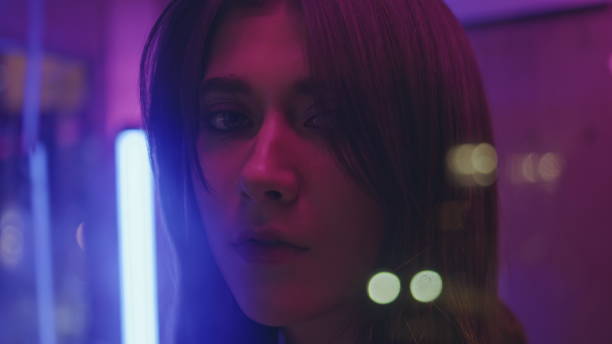 istock Smoking woman posing neon city closeup. Romantic model looking camera resting 2158787906