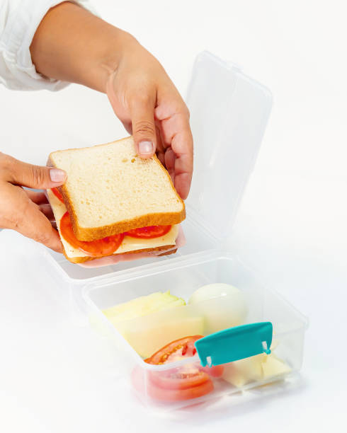 istock Women hand Preparing a Balanced Lunch in a Compartmentalized Container 2158788467