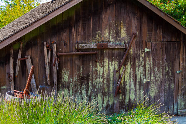 istock Wine Press in Front of Old Barn Door at Winery 2158788952