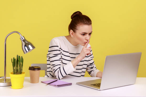 istock Woman employee sitting at workplace shushing with silence gesture, talking on video call. 2158789276
