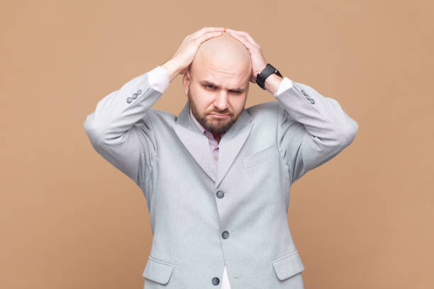 istock Man frowning and clasping sore head, suffering intense headache, having unbearable migraine. 2158789955