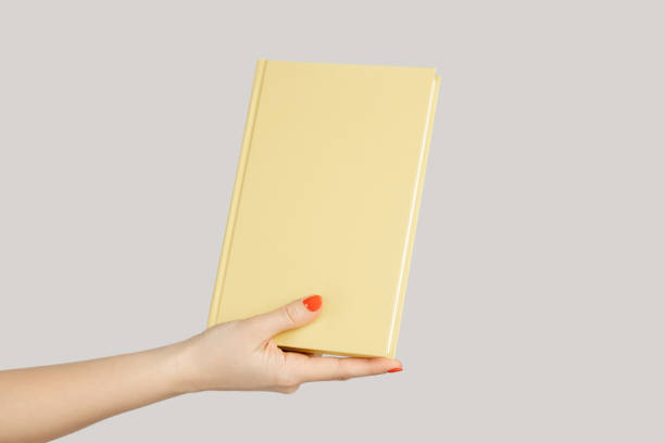 istock Woman hand showing textbook or organizer with empty cover. 2158790008