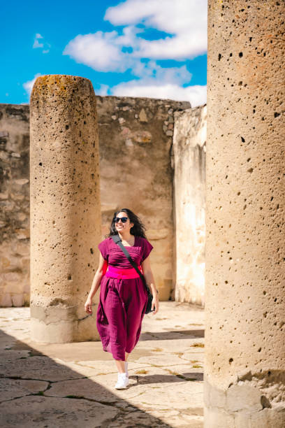 istock Smiling Latina Woman Walking in Mitla Ruins 2158791696