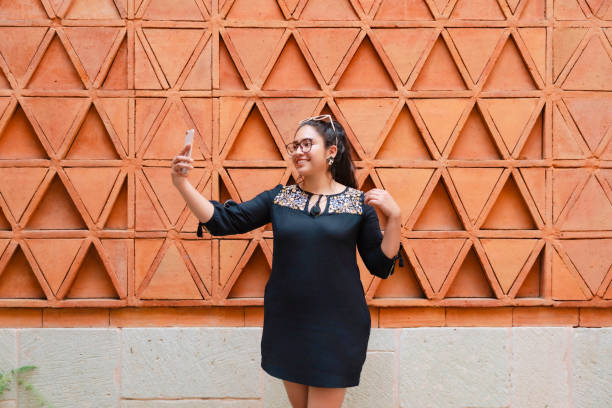 Latina Woman Taking Selfie at Oaxaca Wall
