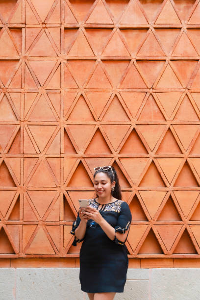 istock Latina Woman Taking Selfie at Oaxaca Wall 2158791781