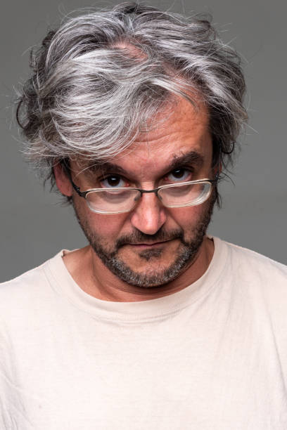 istock Mature man looking at the camera on  gray background 2158794349