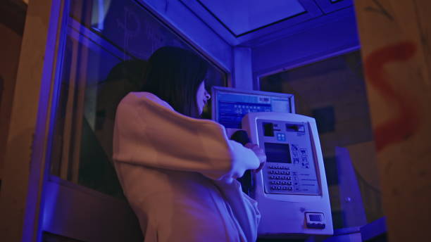 istock Heartbroken lady standing phone booth in neon light closeup. Sad woman calling 2158794965