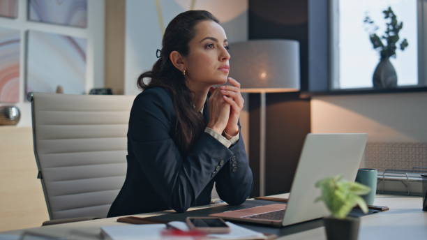 istock Thoughtful ceo sitting desk laptop office closeup. Smiling lady looking camera 2158796205