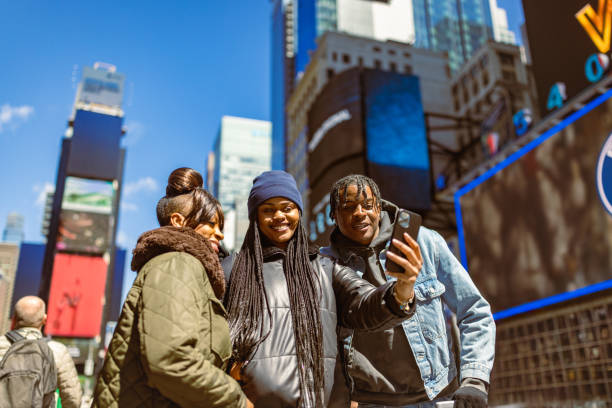 istock Young Friends Taking Selfie in Times Square Morning 2158798649