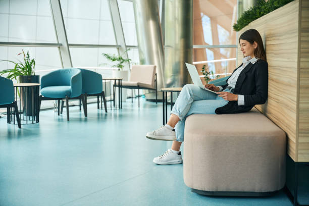 istock Young girl works on outsourcing while sitting in coworking space 2158798782