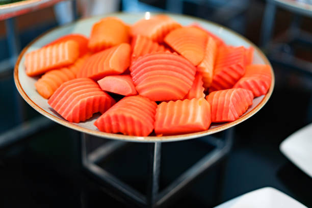 sliced riped papaya in plate on buffet
