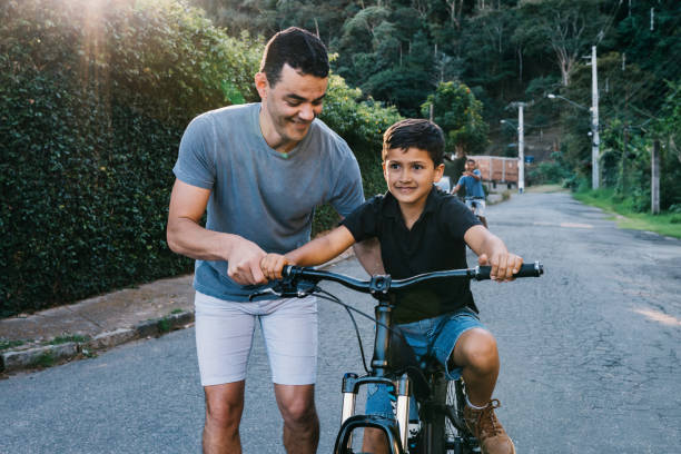 istock Dad teaching his son to ride a bike 2158802743