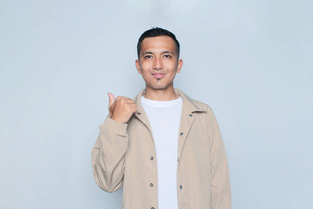 Portrait of a handsome young man gesturing thumbs up