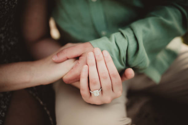istock Couple with engagement ring wedding planning 2158806781