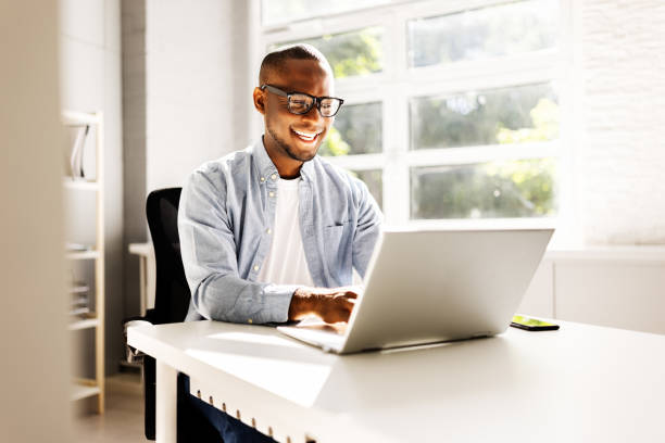 istock African American businessman laughing at his modern office 2158807930