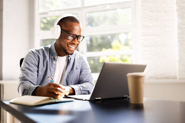istock Young African American man excels in online education, studying with laptop 2158807953