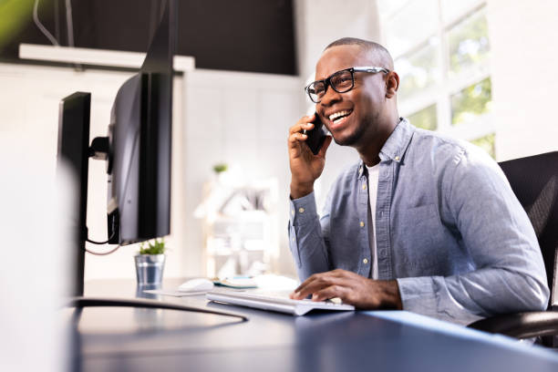 istock High-Tech Real Estate Executive Making a Cheerful Call at His Corporate Office 2158807958