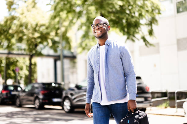 istock Young male corporate executive networking in bustling urban downtown 2158807989