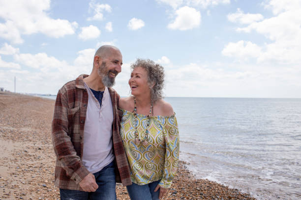istock Senior couple walking on the beach 2158808520