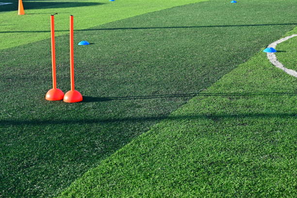 istock artificial green grass soccer field with orange training cones 2158809824