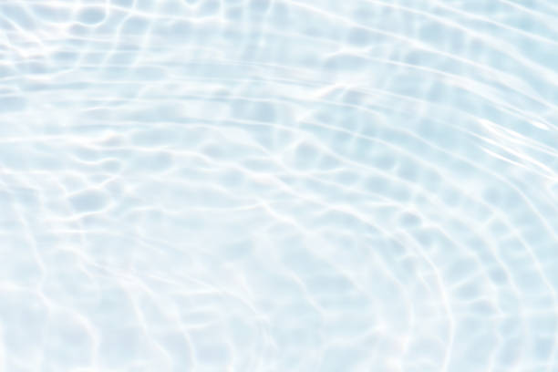 istock Blue water with ripples on the surface. Defocus blurred transparent blue colored clear calm water surface texture with splashes and bubbles. Water waves with shining pattern texture background. 2158810132