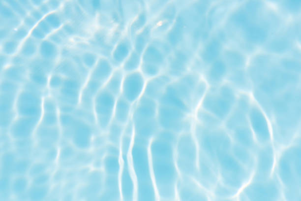 istock Blue water with ripples on the surface. Defocus blurred transparent blue colored clear calm water surface texture with splashes and bubbles. Water waves with shining pattern texture background. 2158810175