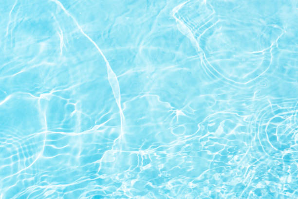 istock Blue water with ripples on the surface. Defocus blurred transparent blue colored clear calm water surface texture with splashes and bubbles. Water waves with shining pattern texture background. 2158810181
