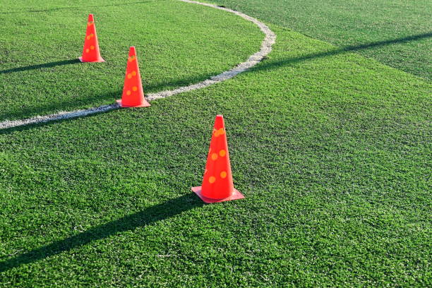 istock artificial green grass soccer field with orange training cones 2158810198